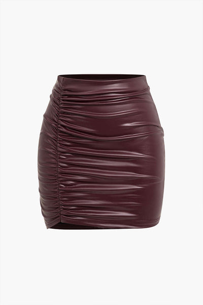 Jocasta | Figure-hugging faux leather mini skirt with side ruching and asymmetrical hem 0