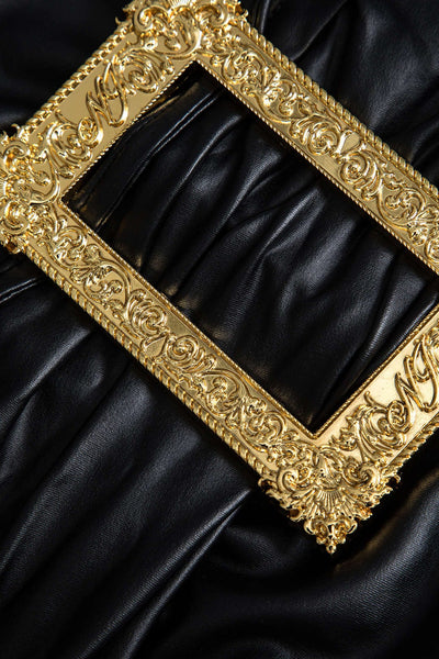 Lyra | Figure-hugging faux leather mini skirt with asymmetrical draping and gold decorative buckle 3